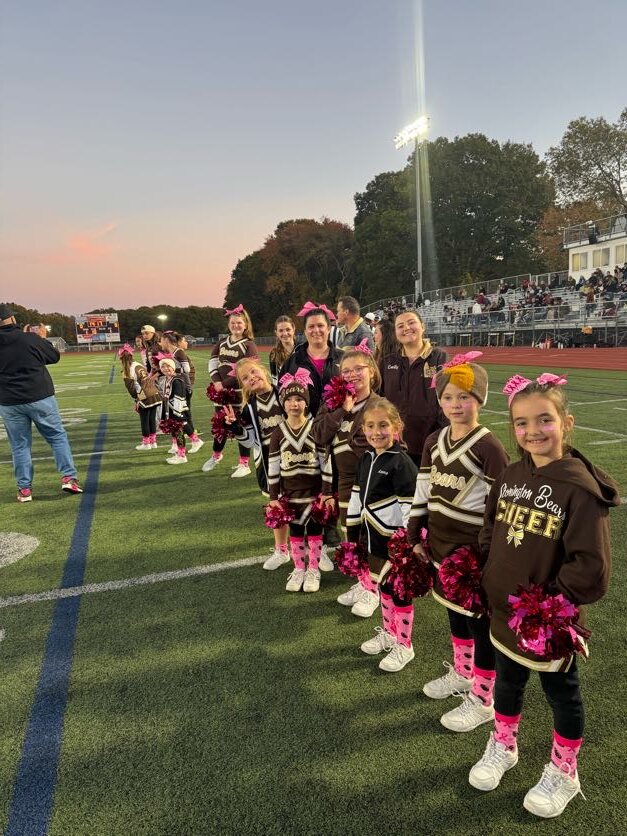 Stonington Bears cheerleaders lined up on the sideline at a sunset game day